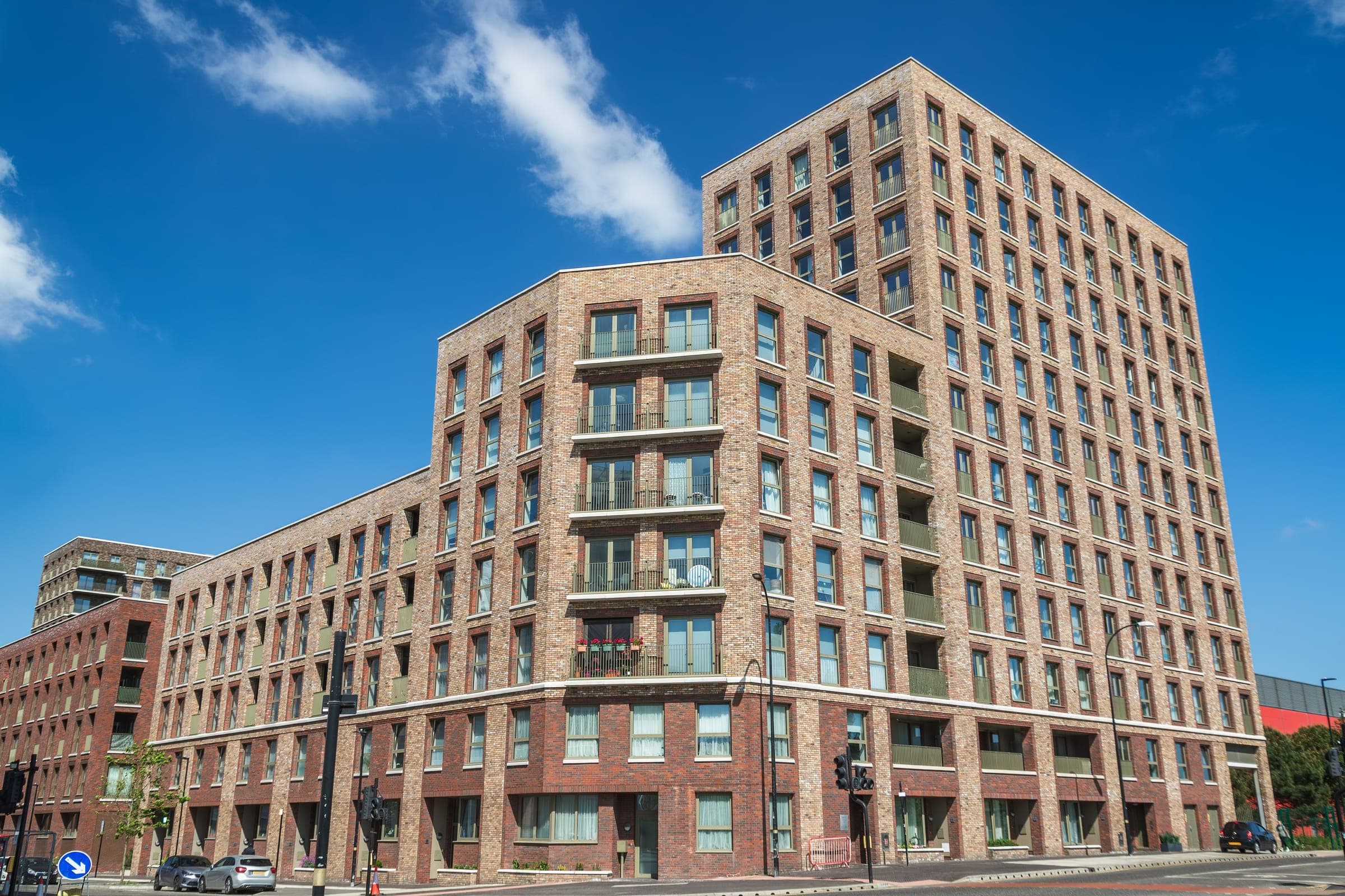 A modern residential apartment block with balconies to each storey.
